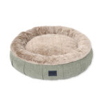 Round dog bed with raised walls and faux fur calming lining in light green sage colour