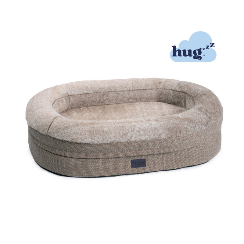 Round dog bed with raised walls, plush faux fur in a light brown colour puppachino and hugzzz filling