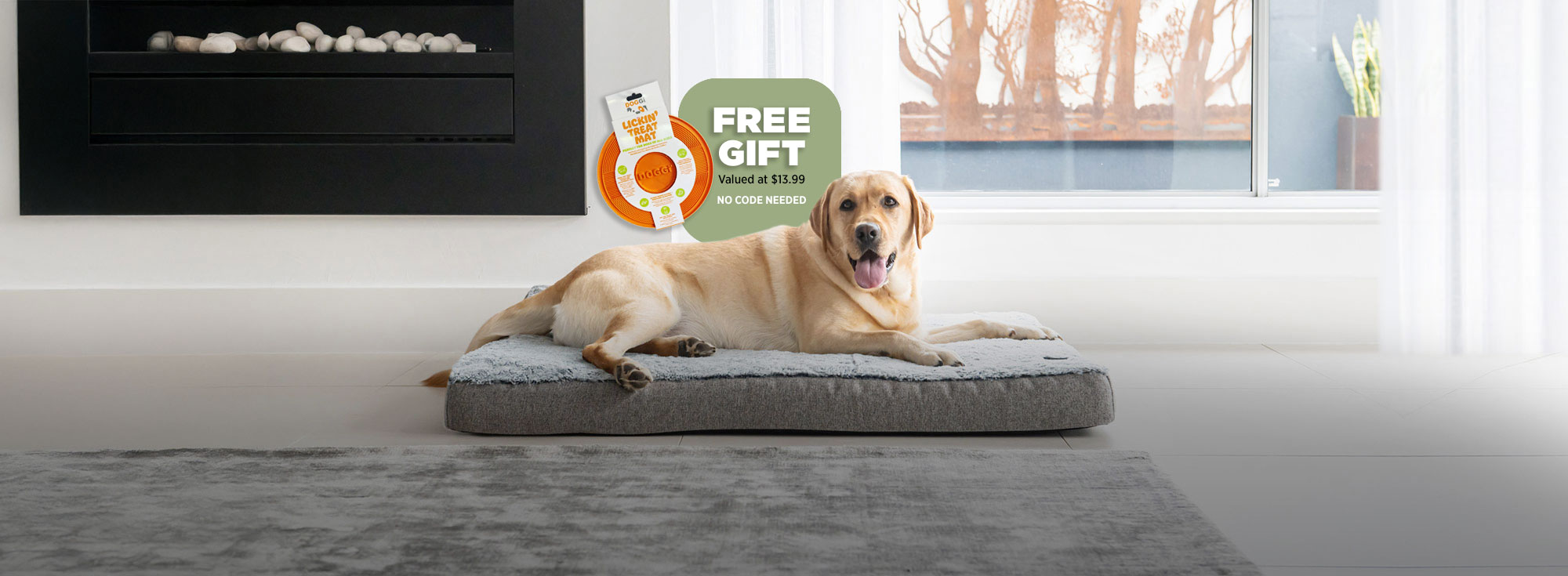 A labrador laying on a Superior Pet Goods grey ortho dog mat with the offer of a free lick mat
